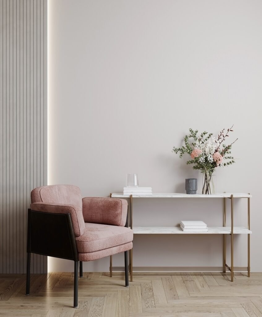 Modern classic interior with paneling, pink chair, wood floor and console